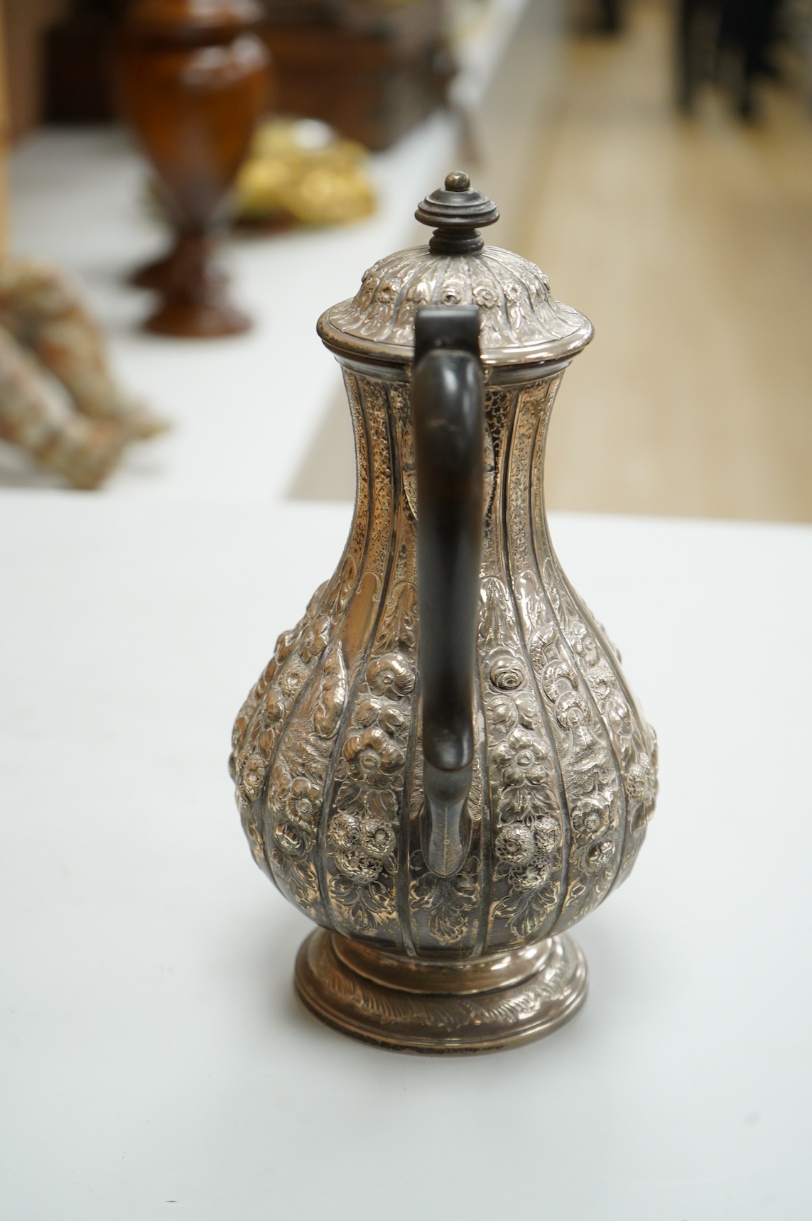 A late Victorian embossed silver hot water jug, of baluster form, F.B. Thomas & Co, London, 1892, height 25.5cm, gross weight 18.4oz.